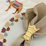 Bukhur gold napkin ring with napkin and placemat bg