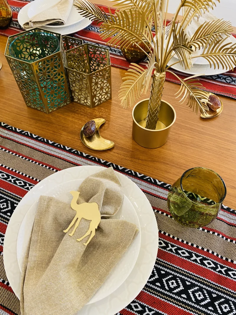 Camel gold napkin ring with beige napkin and plate bg