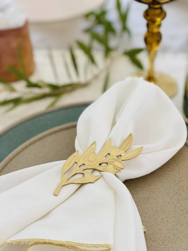 Olive Tree Leaves gold napkin rings with napkin _ blur bg